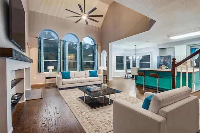 a view of a big room with wooden floor windows and a fireplace