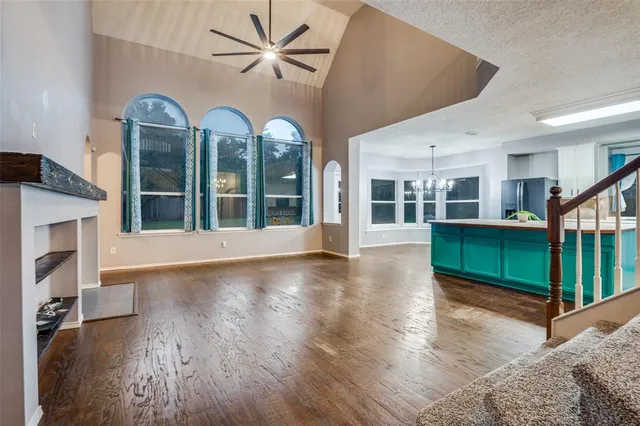 a view of a livingroom with wooden floor and stairs
