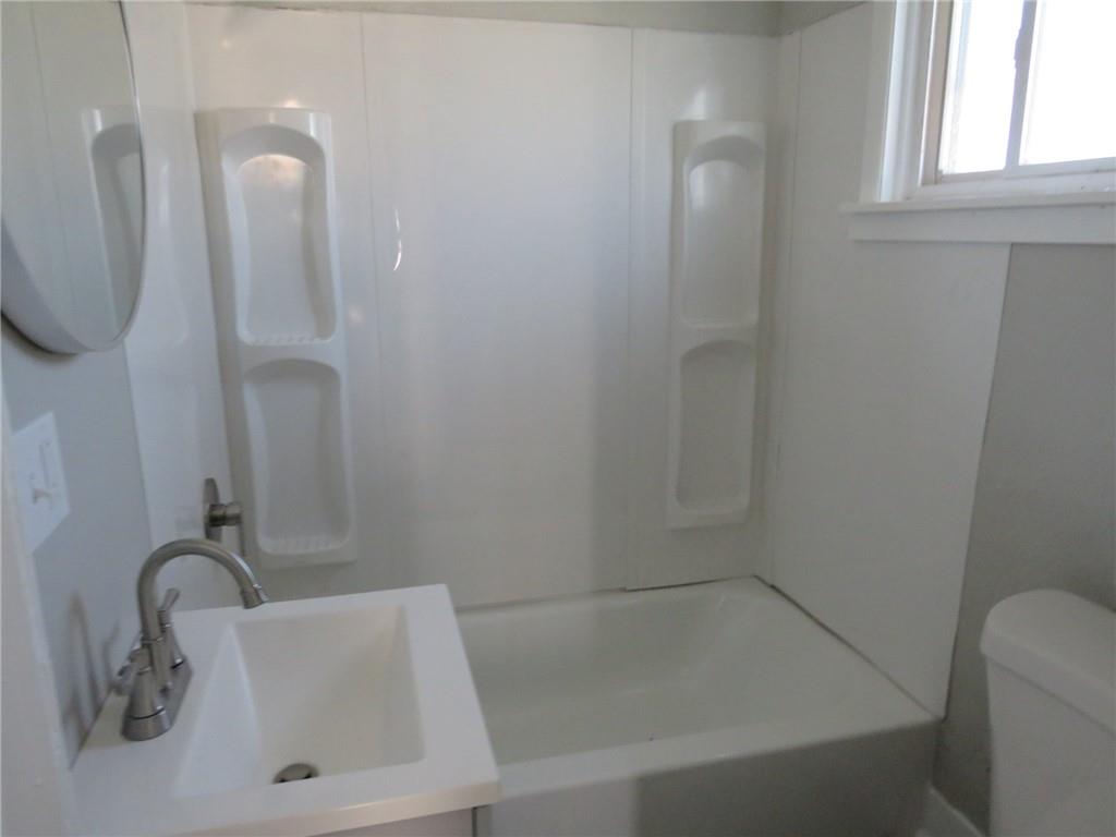 301 Paur Street Pittsburgh, PA 15211 - Photo 12 of 19 a bathroom with a sink a toilet and shower