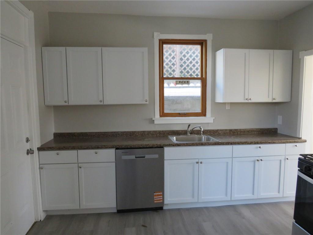 301 Paur Street Pittsburgh, PA 15211 - Photo 13 of 19 a kitchen with granite countertop white cabinets and a sink