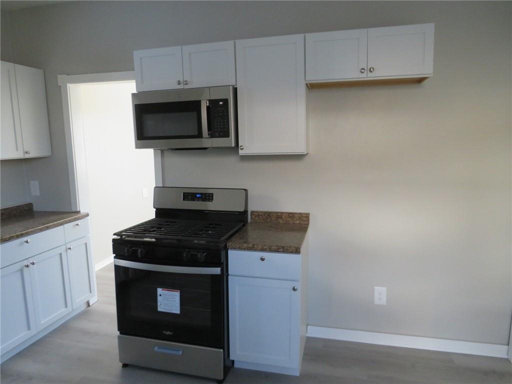 301 Paur Street Pittsburgh, PA 15211 - Photo 14 of 19 a kitchen with a stove and a microwave