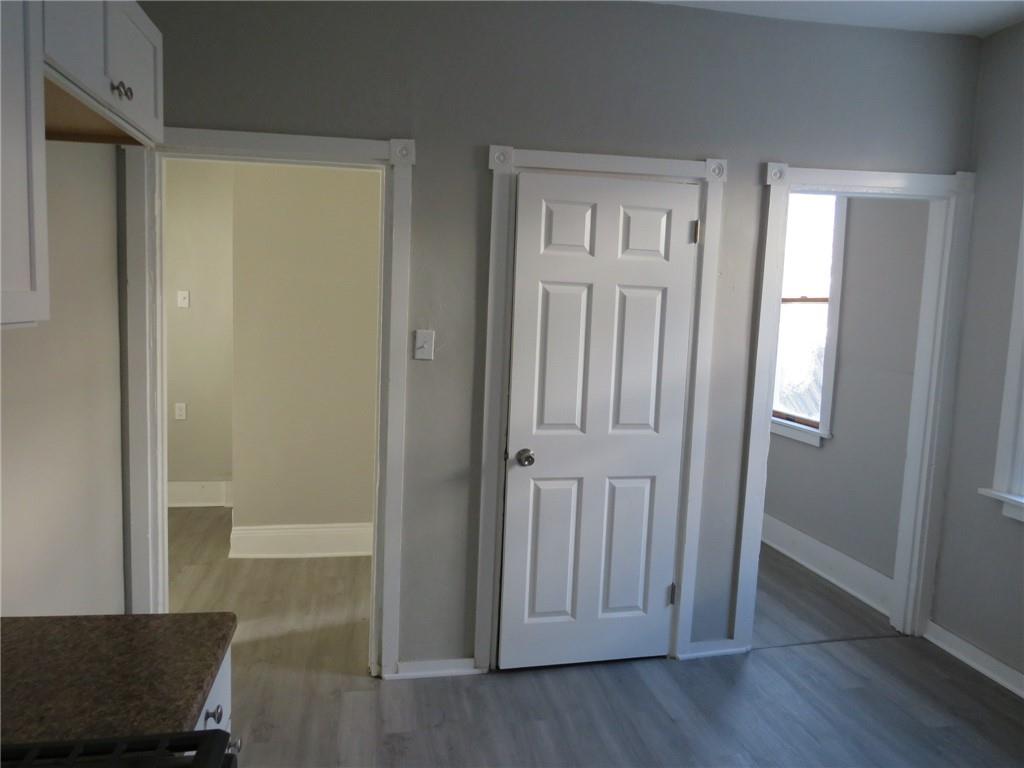 301 Paur Street Pittsburgh, PA 15211 - Photo 15 of 19 an empty room with wooden floor door and windows