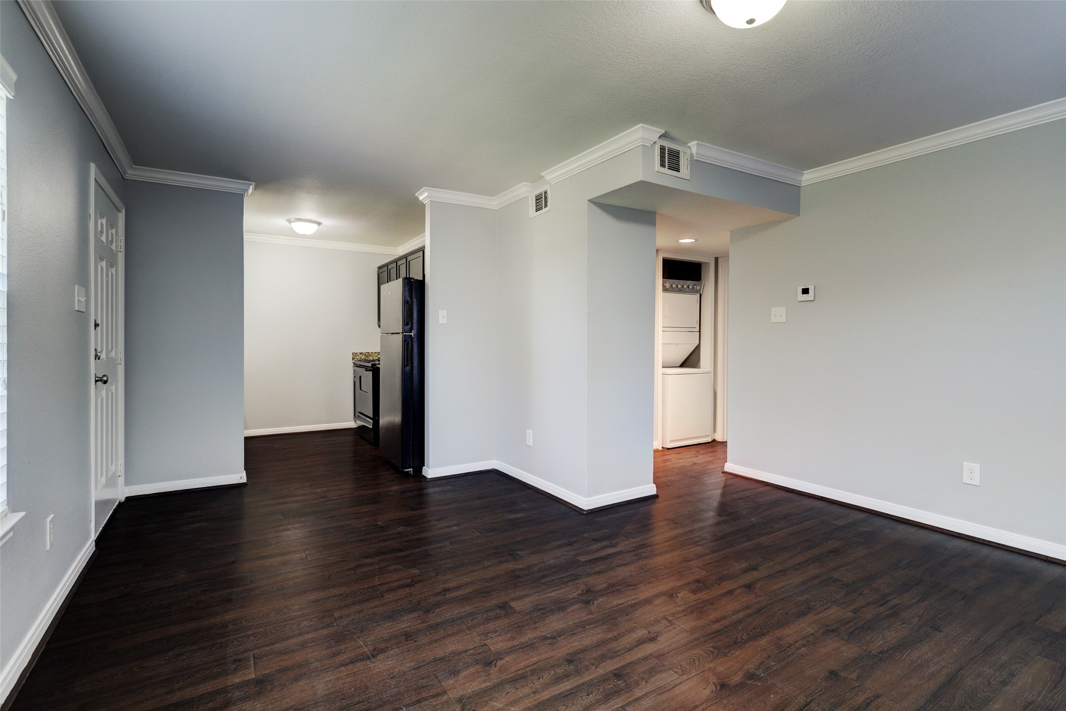 1600 West T C Jester Boulevard, Unit 1 Houston, TX 77008 - Photo 2 of 9 wooden floor in an empty room with a window