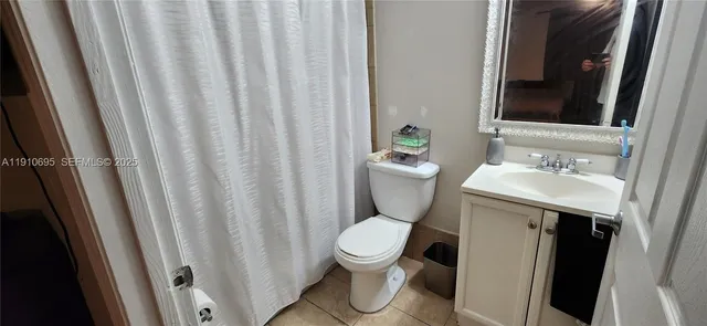 a white toilet sitting next to a bathroom sink