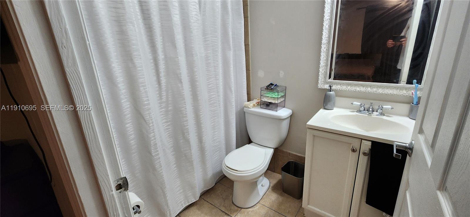 6250 Southwest 130th Avenue, Unit 703 Miami, FL 33183 - Photo 15 of 29 a white toilet sitting next to a bathroom sink