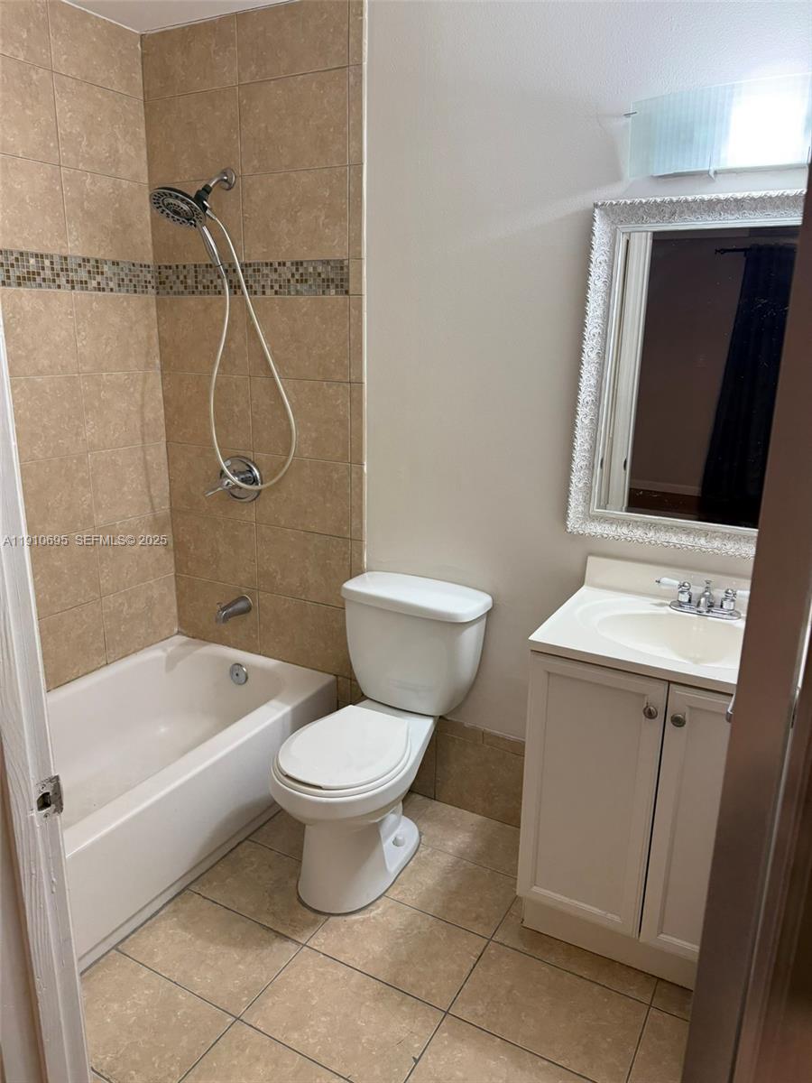 6250 Southwest 130th Avenue, Unit 703 Miami, FL 33183 - Photo 19 of 29 a bathroom with a toilet sink and shower