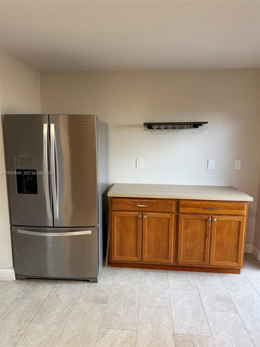 6250 Southwest 130th Avenue, Unit 703 Miami, FL 33183 - Photo 3 of 29 a kitchen with granite countertop a refrigerator and a sink