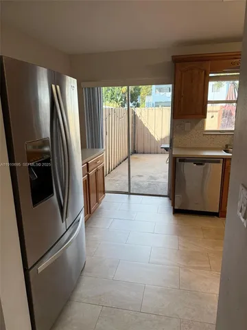 a kitchen with stainless steel appliances a refrigerator sink and cabinets