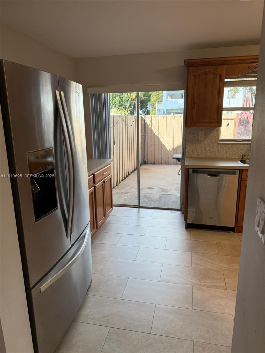 6250 Southwest 130th Avenue, Unit 703 Miami, FL 33183 - Photo 4 of 29 a kitchen with stainless steel appliances a refrigerator sink and cabinets