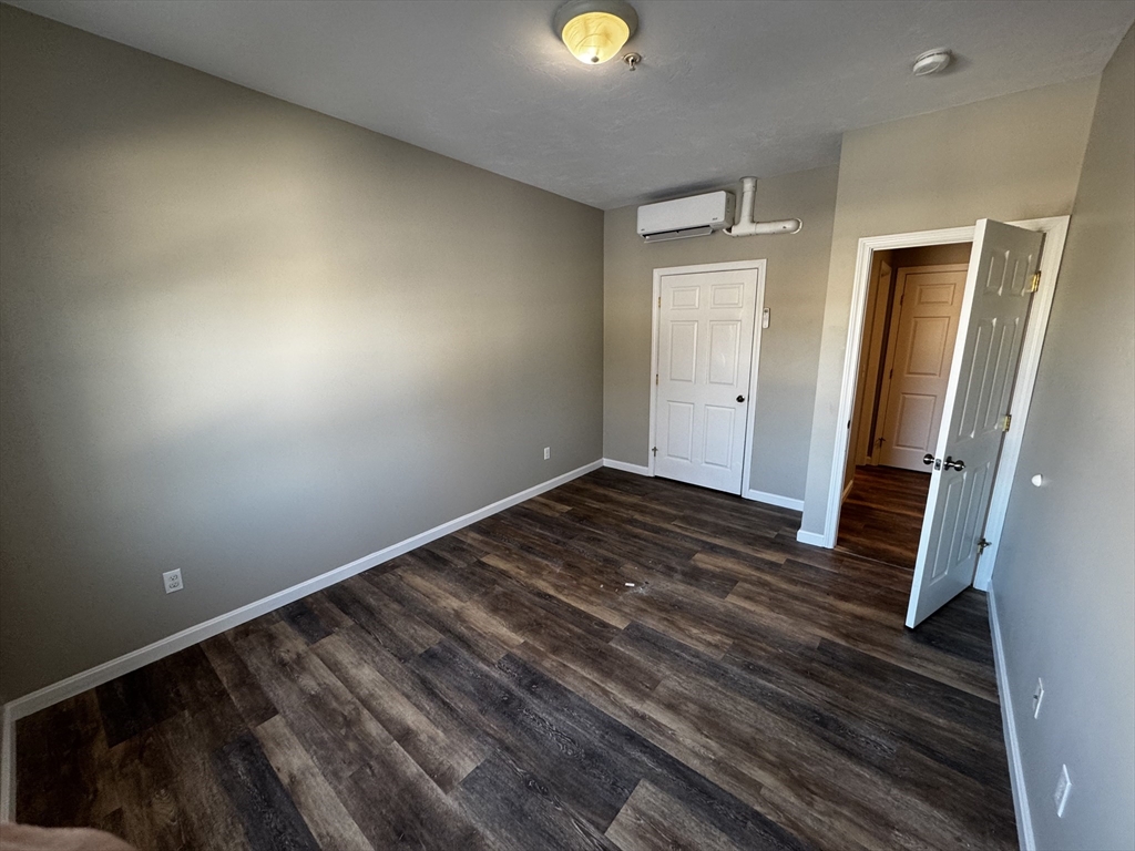 95 Park Street, Unit 2 Attleboro, MA 02703 - Photo 3 of 10 a view of a room with wooden floor and staircase