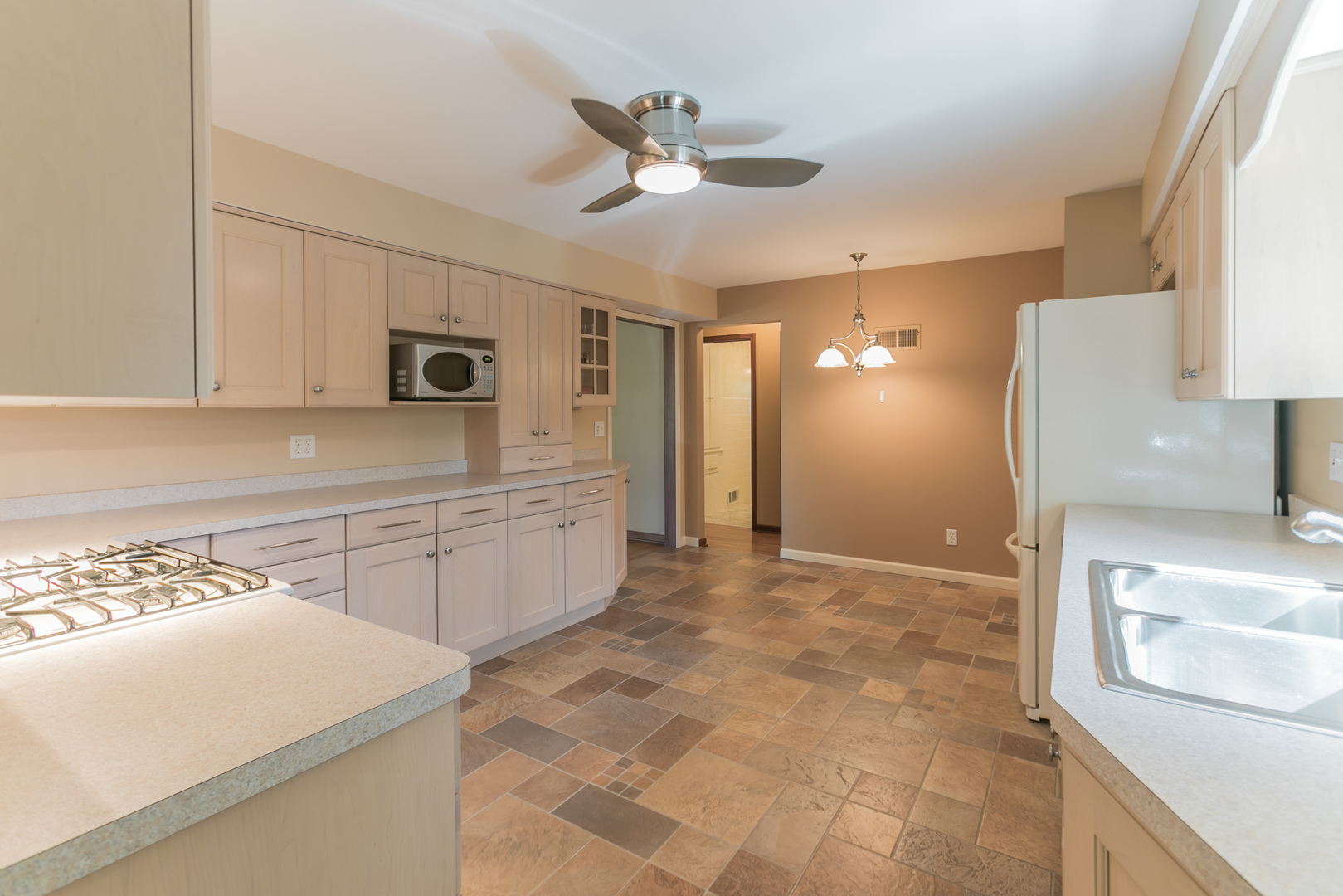 919 Meadows Road Geneva, IL 60134 - Photo 11 of 25 a kitchen with stainless steel appliances granite countertop a sink a stove a refrigerator a microwave oven with white cabinets