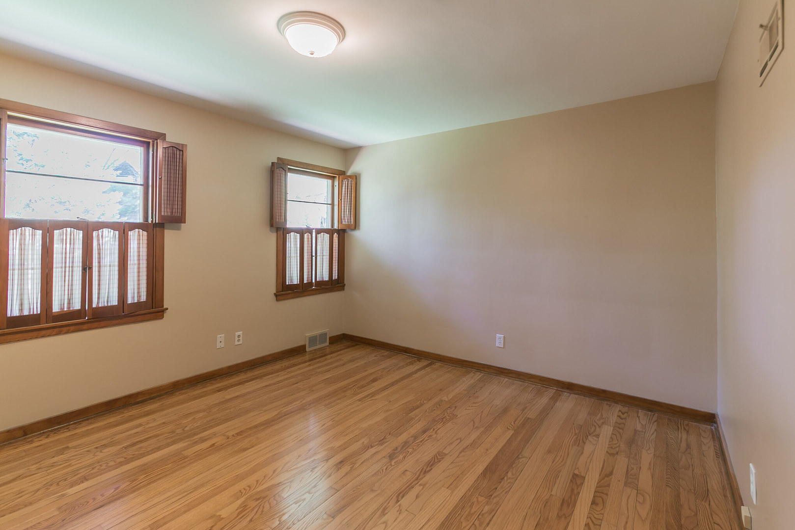 919 Meadows Road Geneva, IL 60134 - Photo 16 of 25 a view of an empty room with wooden floor and a window