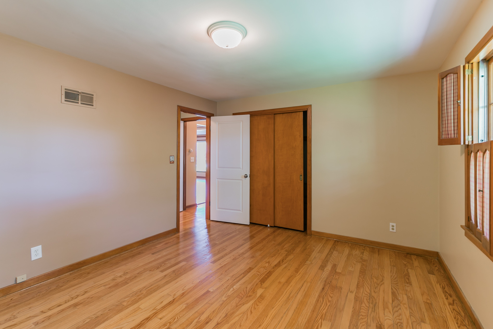 919 Meadows Road Geneva, IL 60134 - Photo 17 of 25 an empty room with wooden floor and windows