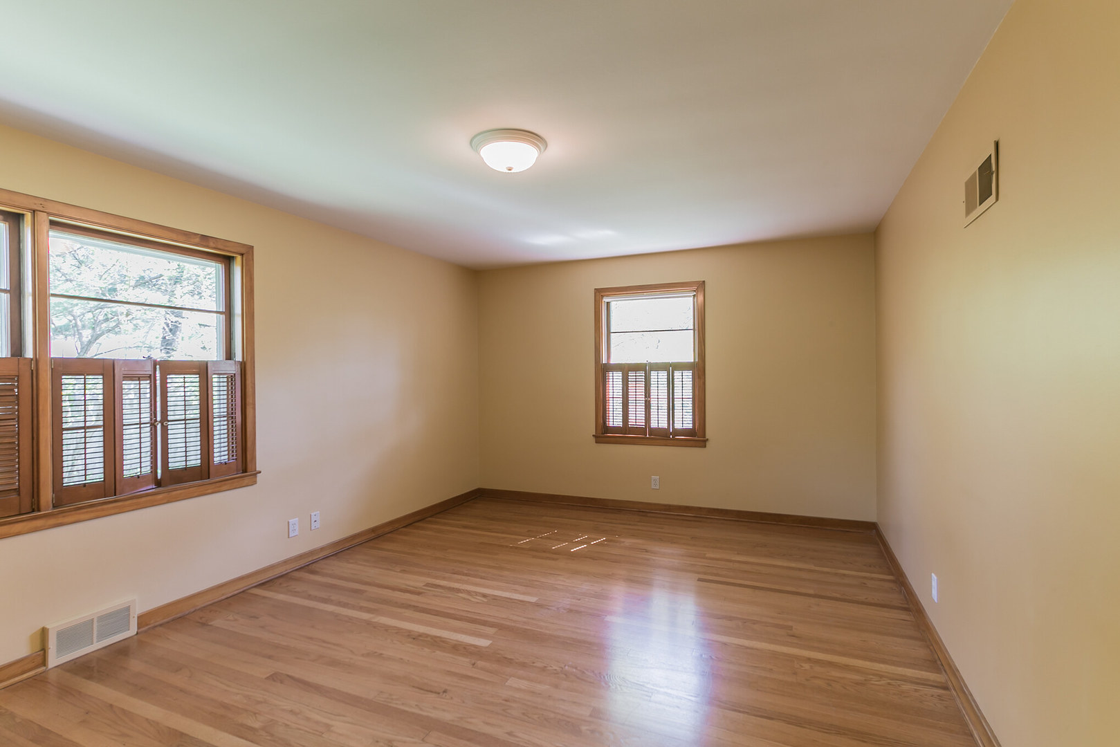 919 Meadows Road Geneva, IL 60134 - Photo 19 of 25 a view of an empty room with wooden floor and a window