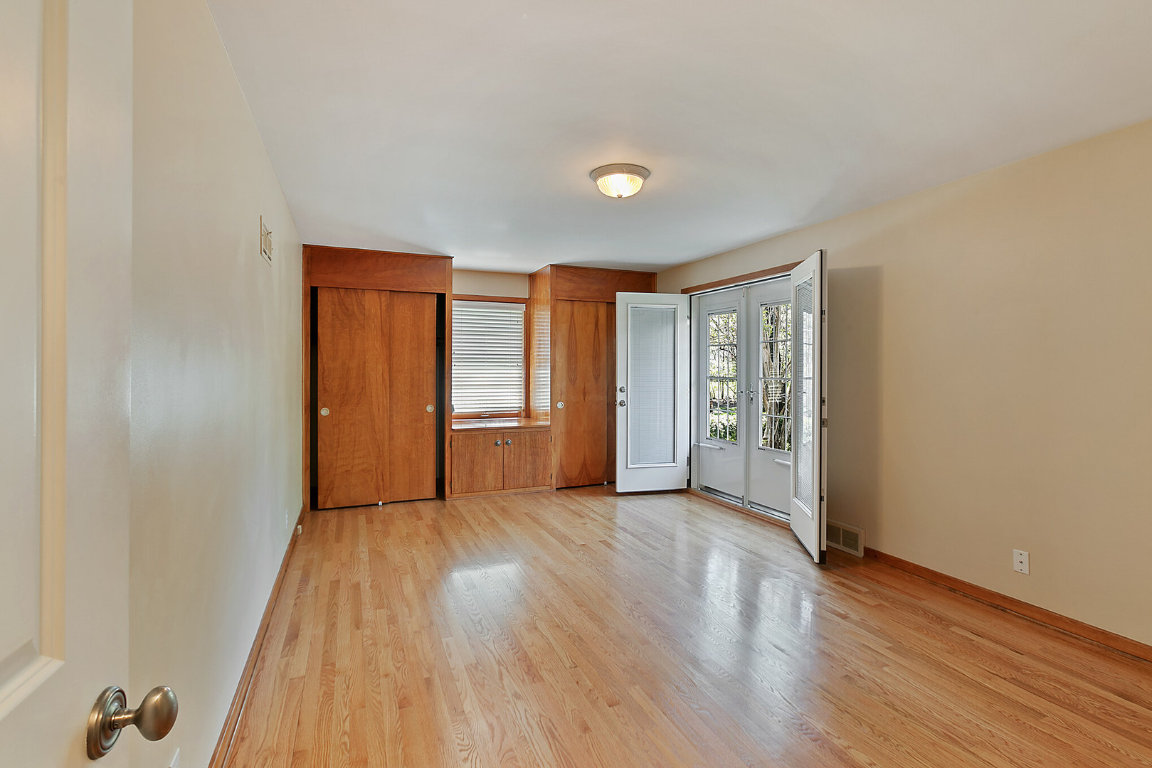 919 Meadows Road Geneva, IL 60134 - Photo 21 of 25 an empty room with wooden floor and windows