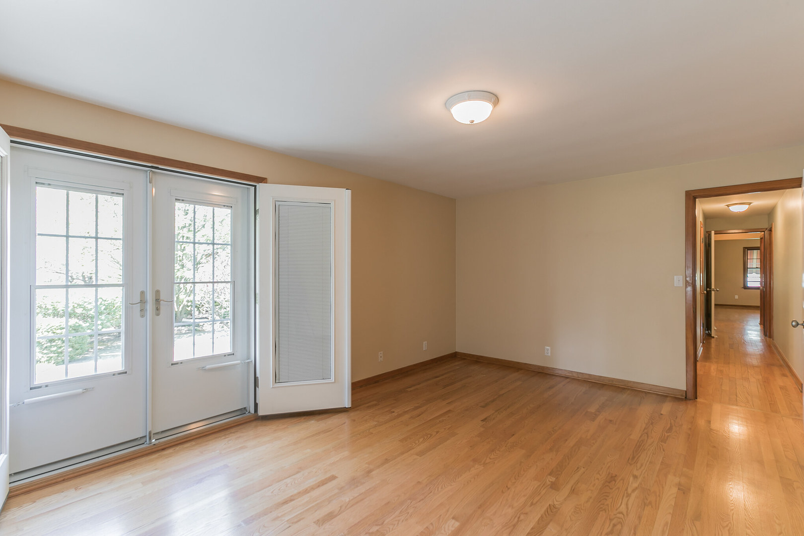 919 Meadows Road Geneva, IL 60134 - Photo 22 of 25 a view of an empty room with wooden floor and a window