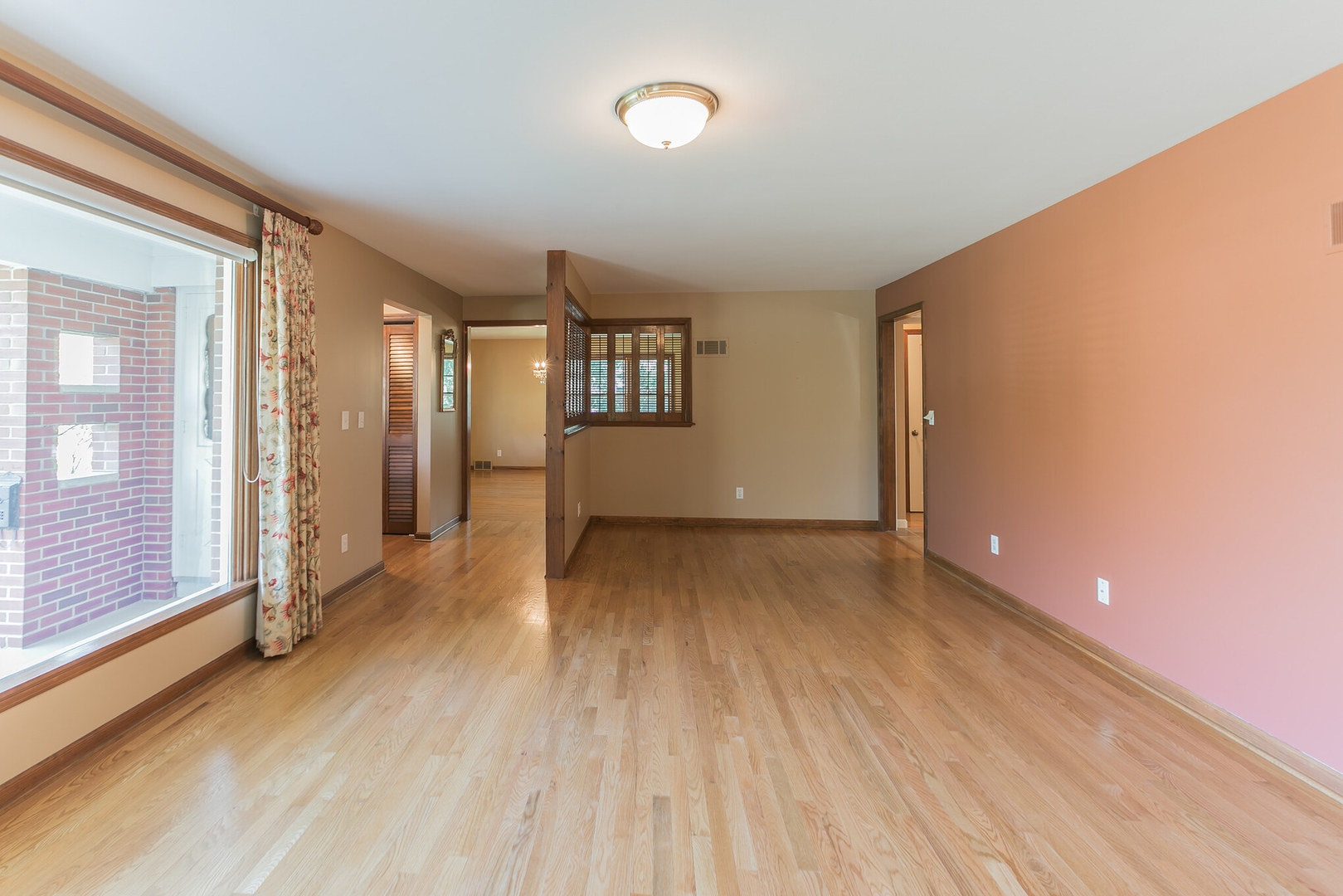 919 Meadows Road Geneva, IL 60134 - Photo 4 of 25 a view of a room with wooden floor and window