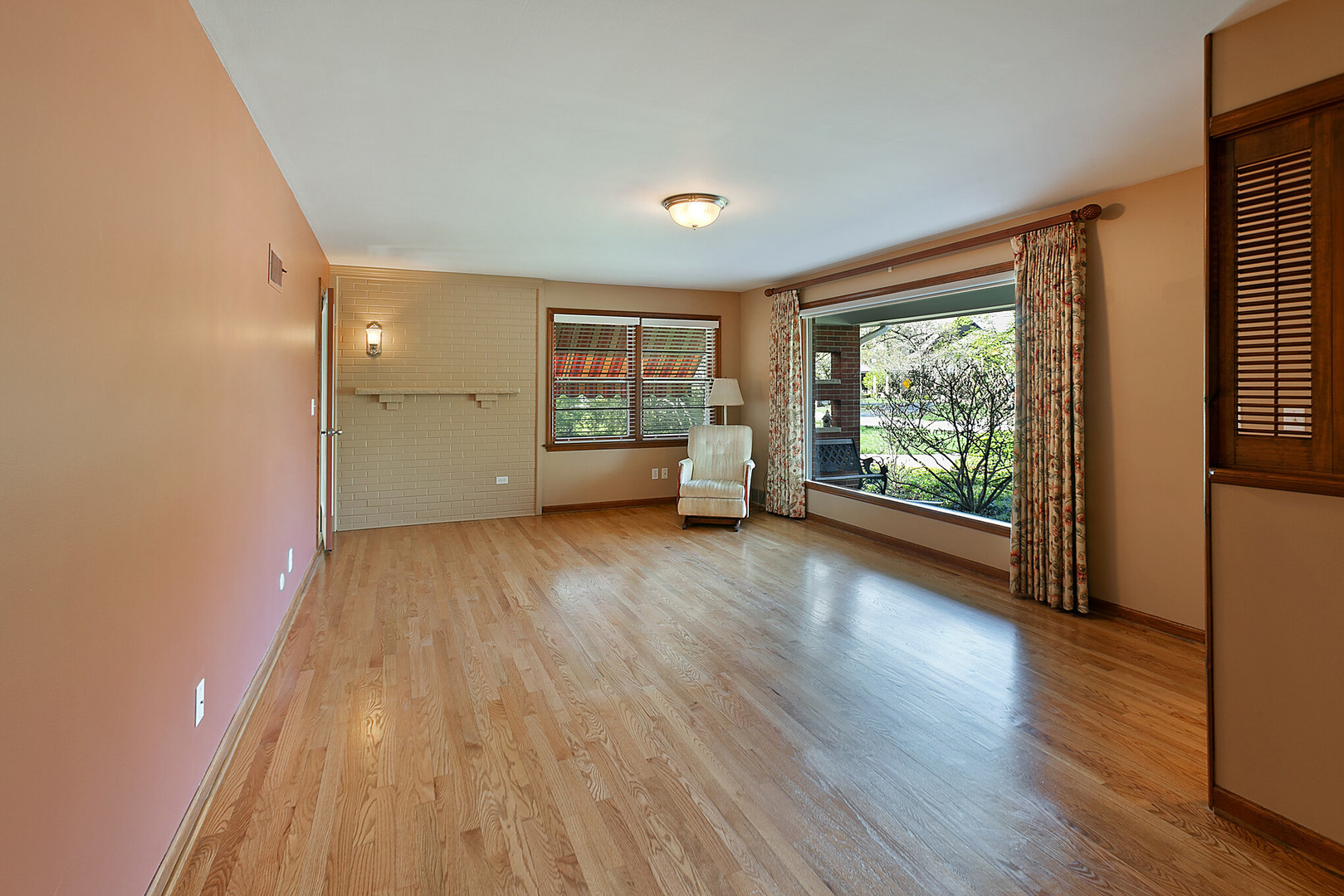 919 Meadows Road Geneva, IL 60134 - Photo 5 of 25 a view of empty room with wooden floor and fan