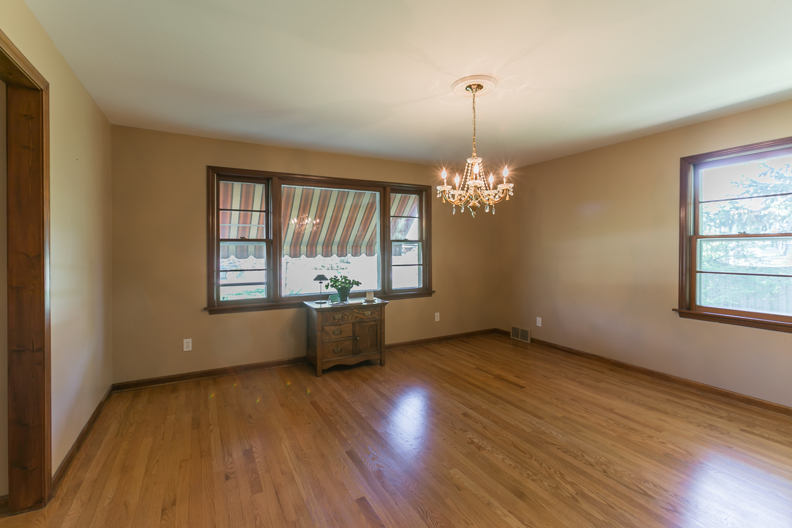 919 Meadows Road Geneva, IL 60134 - Photo 7 of 25 wooden floor in an empty room with a window