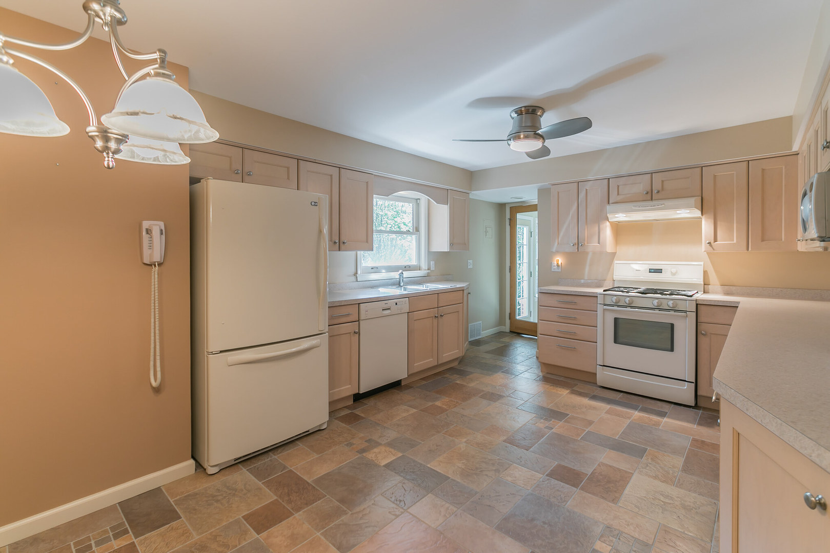 919 Meadows Road Geneva, IL 60134 - Photo 9 of 25 a kitchen with a refrigerator a sink and dishwasher