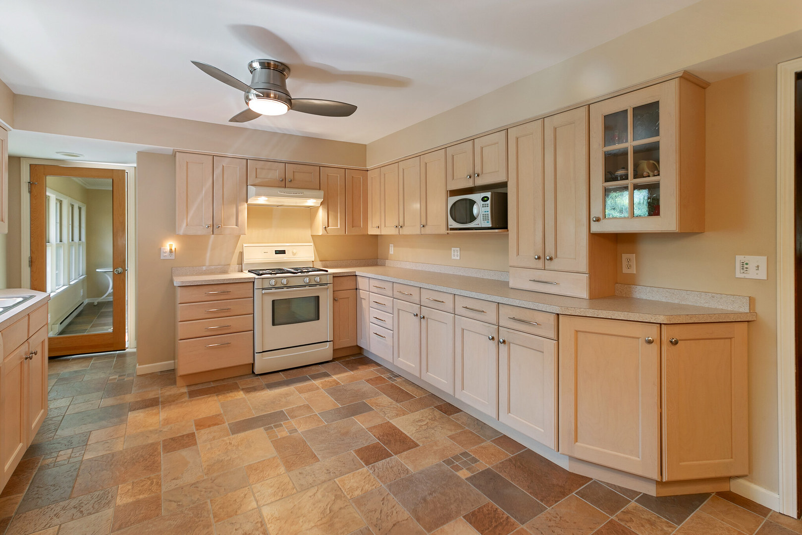 919 Meadows Road Geneva, IL 60134 - Photo 10 of 25 a kitchen with granite countertop a stove top oven sink and cabinets