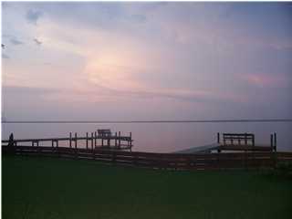 1570 Indian Woman Road Santa Rosa Beach, FL 32459 - Photo 2 of 11 a view of a lake with house in background