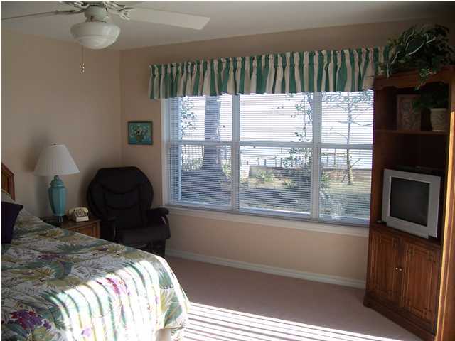 1570 Indian Woman Road Santa Rosa Beach, FL 32459 - Photo 6 of 11 a bed sitting in a bedroom next to a window