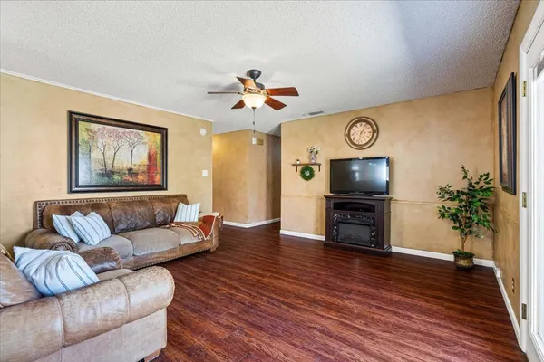 a living room with furniture a flat screen tv and a fireplace