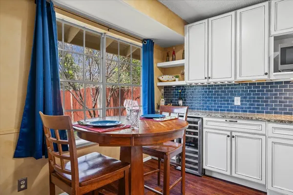 a dining room with furniture a rug and wooden floor