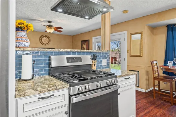 a kitchen with a stove and a table