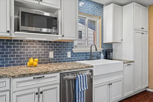 a kitchen with a sink stove and cabinets