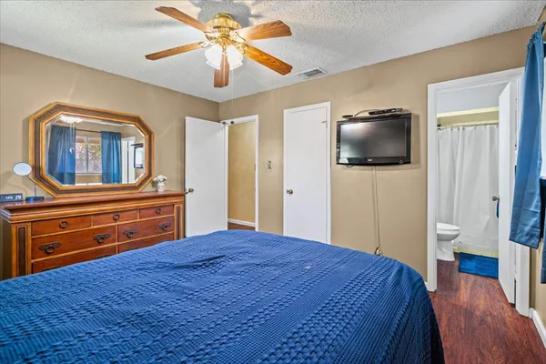 a bedroom with a bed and a flat screen tv