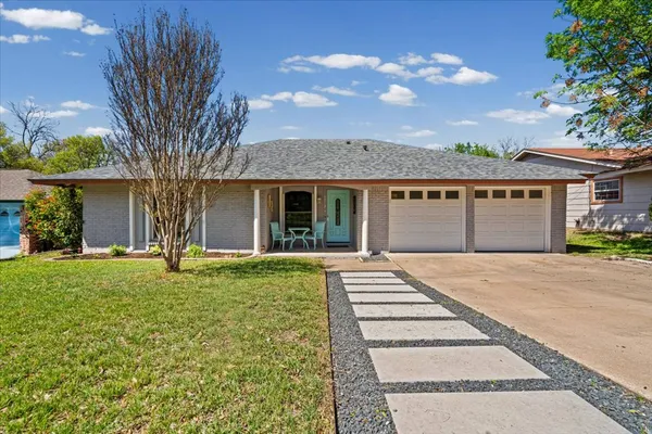 front view of a house with a garden