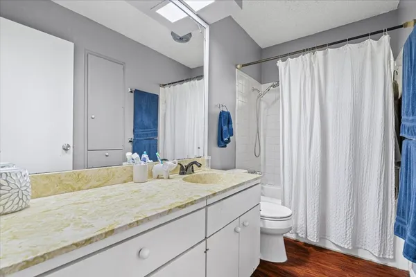 a bathroom with a granite countertop sink and a mirror