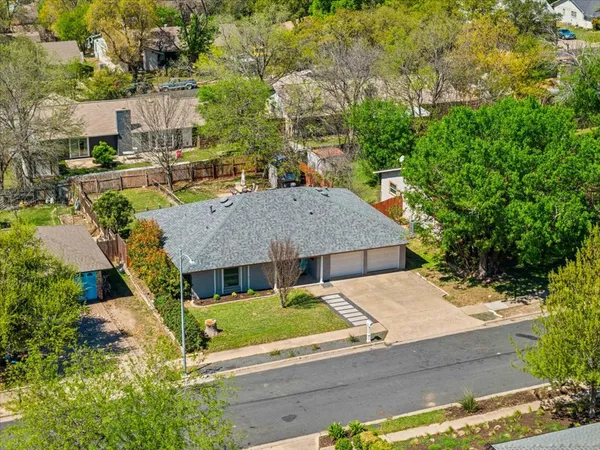an aerial view of a house with yard