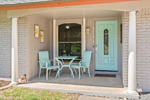 a dining room with furniture and a window