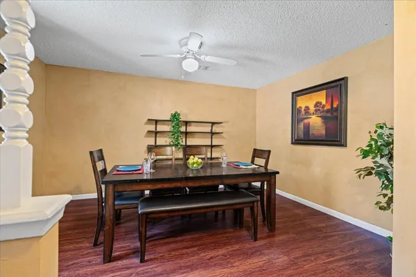 a view of a dining room with furniture and wooden floor