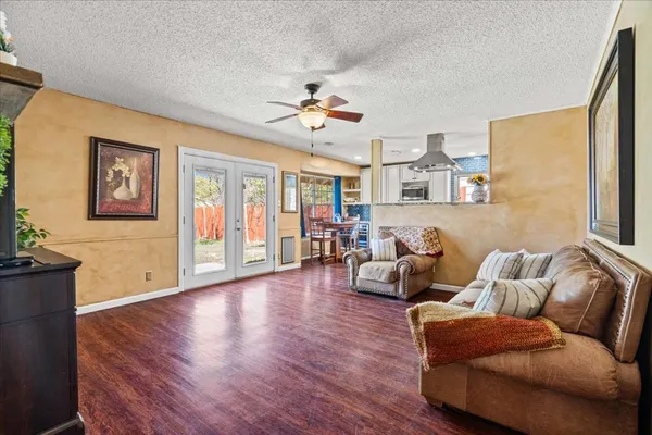a living room with furniture a ceiling fan and a window