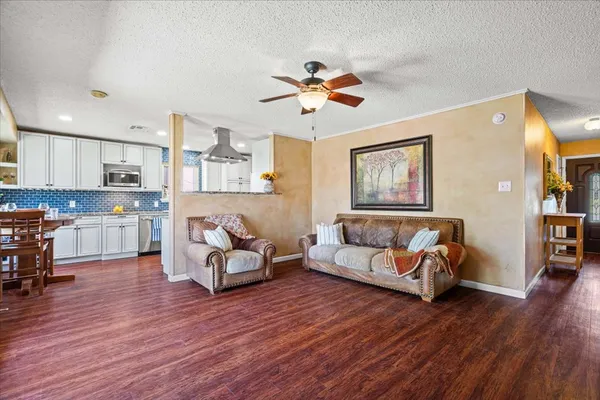 a living room with furniture and wooden floor
