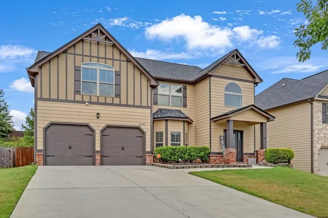 a front view of a house with a yard and garage