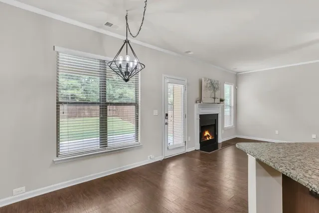 a view of a kitchen with stainless steel appliances granite countertop a refrigerator and a sink