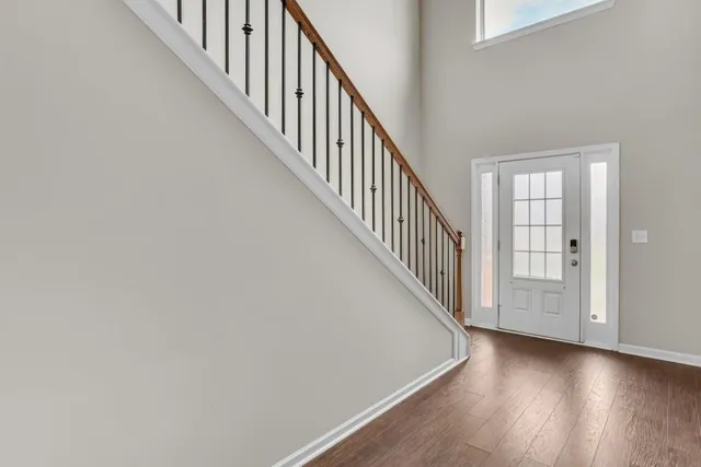 a view of a hallway with wooden floor and entryway
