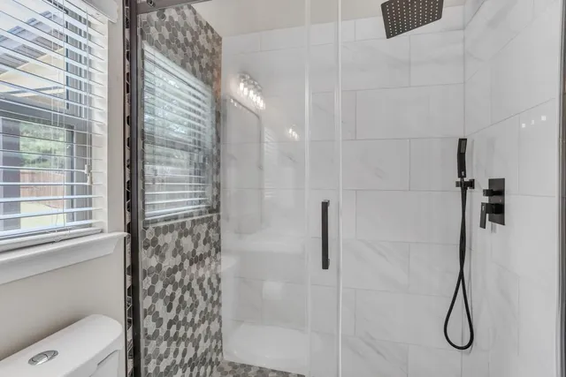 an empty room with chandelier fan