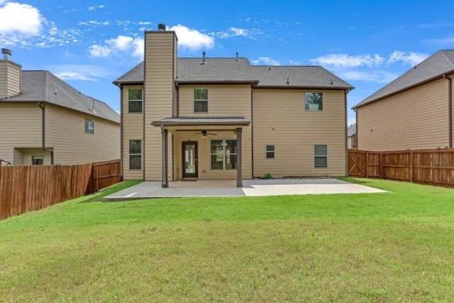 a view of a house with a yard and porch