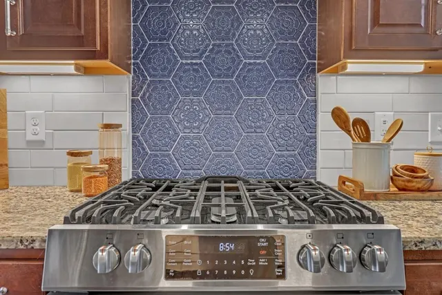 a stove top oven sitting inside of a kitchen