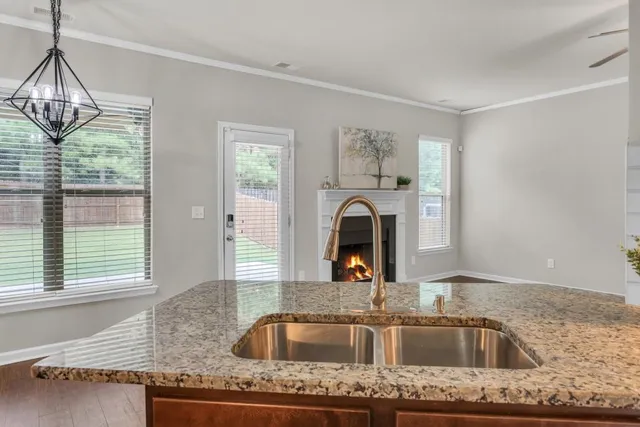 a kitchen with granite countertop a sink and a window