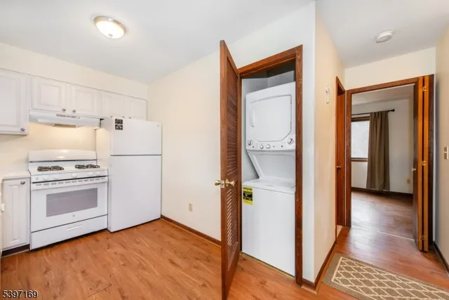a view of a kitchen with a sink refrigerator and cabinet