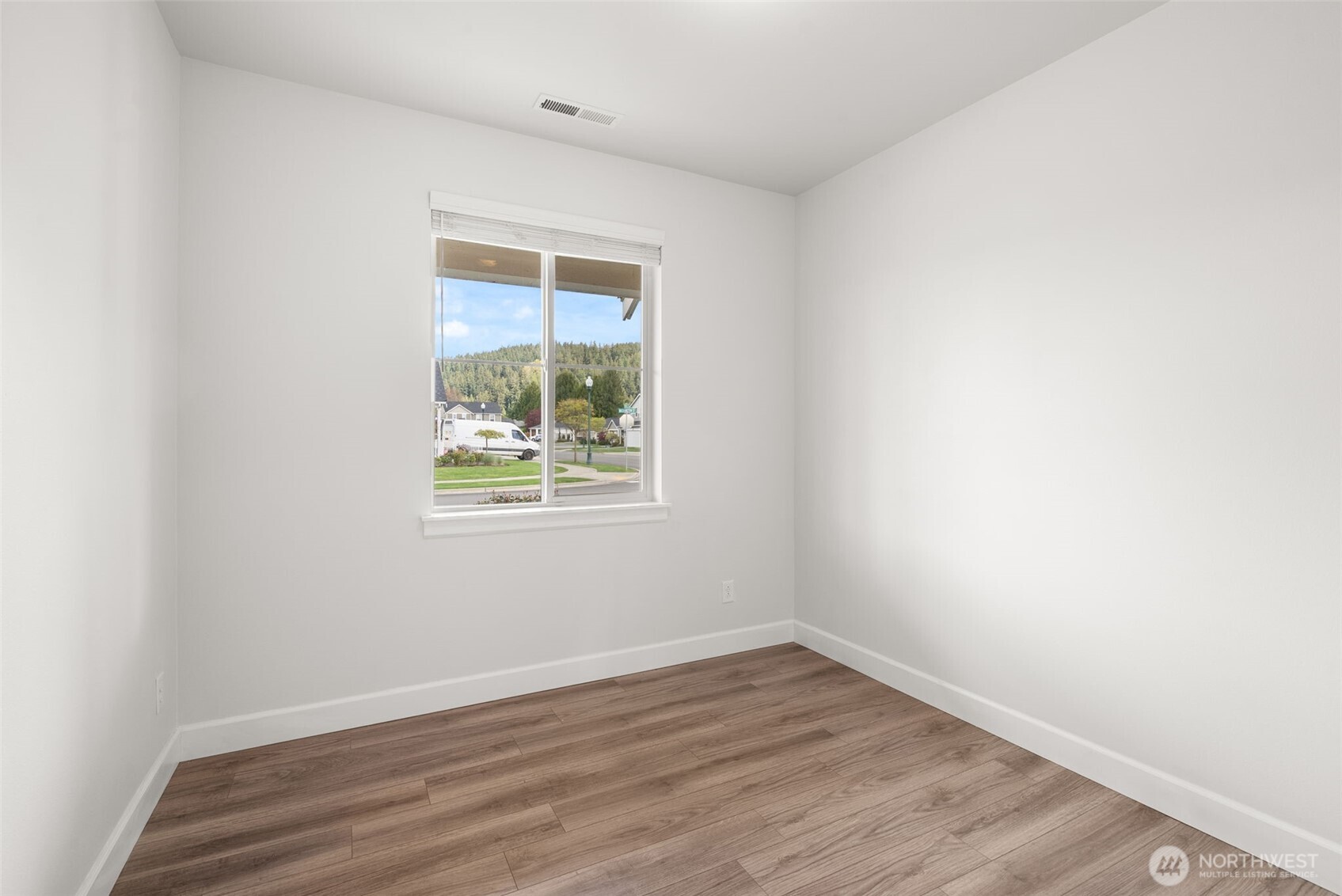 15696 Washington Street Sumner, WA 98390 - Photo 13 of 29 an empty room with wooden floor and windows