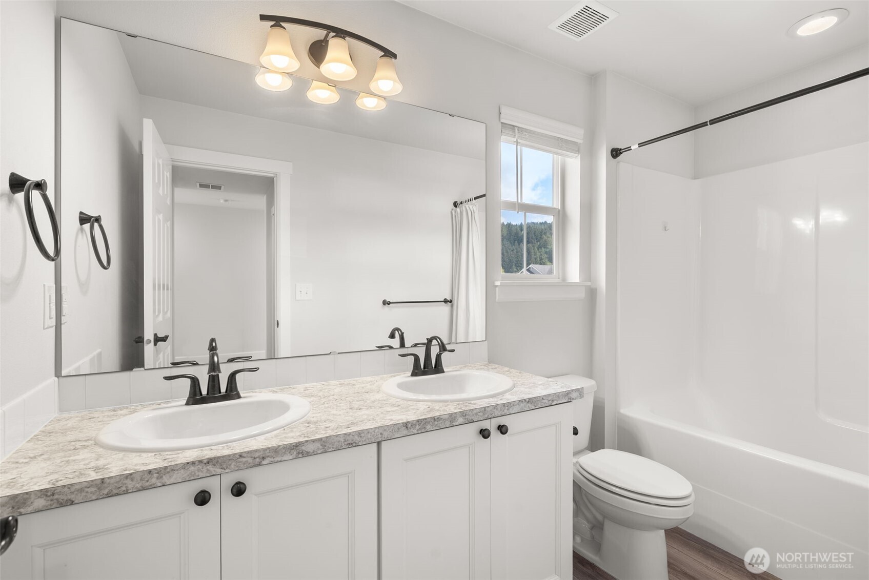 15696 Washington Street Sumner, WA 98390 - Photo 20 of 29 a bathroom with a double vanity sink toilet and a mirror