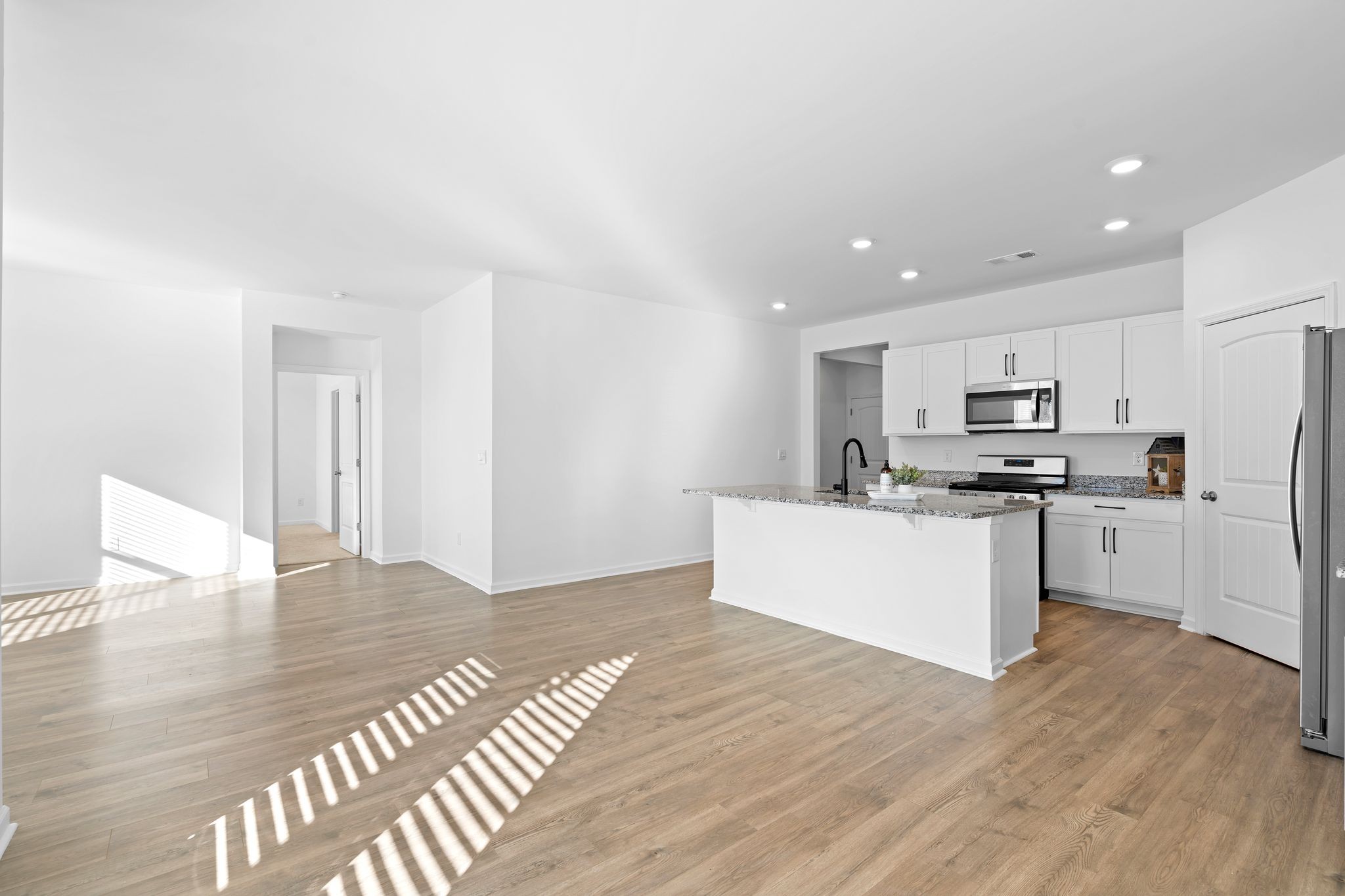 203 Welara Street Murfreesboro, TN 37129 - Photo 17 of 40 a kitchen with stainless steel appliances granite countertop a refrigerator sink and white cabinets
